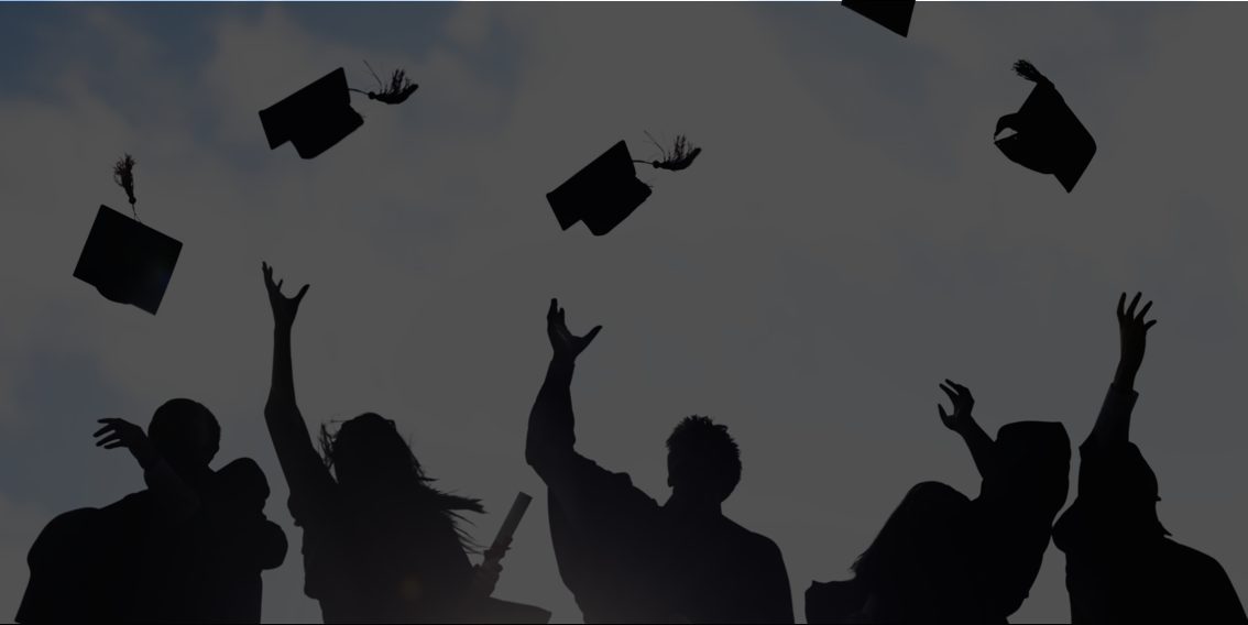 Graduation caps thrown in the air